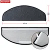 A top and bottom view of a grey, semi-circular stair mat with dimensions indicated. Produktbild-Vorschau