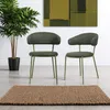 Two green chairs and a potted plant are shown in a room with a painting on the wall and a rug on the floor. Náhled obrázku produktu