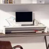 A monitor stand on a desk with a monitor, lamp, and books. Náhled obrázku produktu
