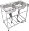 A stainless steel double sink with a metal frame and drainage pipes. Podgląd zdjęcia produktu