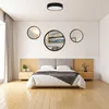 A bedroom scene with a bed, nightstands, and decorative mirrors on the wall. Anteprima dell’immagine prodotto