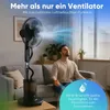 A man meditating in front of a misting fan in a living room. Voir les images du produit