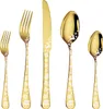 A set of gold-colored cutlery with Christmas-themed decorations. Podgląd zdjęcia produktu