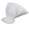 A bag of white granular material, likely sand or filter media, is tipped over, spilling some of its contents onto a white surface. Anteprima dell’immagine prodotto