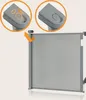 A close-up view of a retractable baby gate with two inset circular diagrams showing the locking mechanism. Voir les images du produit