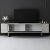 A modern TV stand with a television on top, set against a dark gray paneled wall and a light gray patterned floor. Voir les images du produit