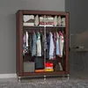 A portable closet filled with clothes and folded items, standing in a room. Anteprima dell’immagine prodotto