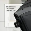 A close-up view of a black rolling cabinet, showing its wheels and a white text overlay. Produktbild-Vorschau