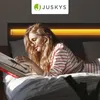 A woman reading in bed with a headboard lamp. Náhľad obrázku produktu
