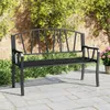 A black metal garden bench is shown outdoors on a paved patio, with greenery and a brick wall in the background. Voir les images du produit