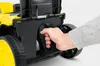 A hand is shown gripping a handle on a lawnmower. Produktbild-Vorschau