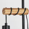 A close-up view of a wooden dowel wrapped with black metal wire, attached to a black pole, with a black cord hanging down. Produktbild-Vorschau