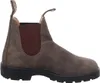 A side view of a brown leather boot on a white background. Voir les images du produit
