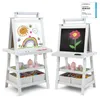 Two white wooden easels for children, each with a drawing surface and storage shelves below, are shown against a white background. The easel on the left has a drawing of a sun, rainbow, and clouds on its whiteboard surface. The easel on the right has a dra Podgląd zdjęcia produktu