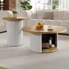 A living room scene with two round coffee tables and a sofa in the background. Produktbild-Vorschau