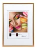 A framed picture of a woman with colorful makeup and macarons. Produktbild-Vorschau
