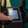 A person's hand is touching the screen of a black EMS machine. Anteprima dell’immagine prodotto