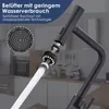 A close-up of a black kitchen faucet with a water-saving aerator, showing water flow and a diagram of the aerator. The background is a blurred kitchen setting. Produktbild-Vorschau