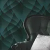 A close-up of a tufted armchair with a patterned wallpaper background. Produktbild-Vorschau