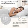 A woman sleeping peacefully in a bed, with close-ups of bedding and feature callouts. Produktbild-Vorschau