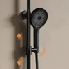 A close-up shot of a black shower system mounted on a wall. Anteprima dell’immagine prodotto