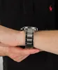 A close-up shot of a person's wrist wearing a silver watch. Produktbild-Vorschau