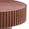 A close-up shot of a round wooden coffee table with a fluted base. Produktbild-Vorschau