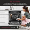 A woman is cleaning the inside of a built-in oven. Produktbild-Vorschau