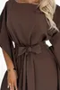 A close-up of a woman wearing a brown dress. Produktbild-Vorschau