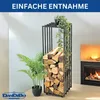 A metal firewood rack filled with logs, placed next to a fireplace and plants. Produktbild-Vorschau