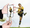 A person is holding a smartphone with a soccer player on the screen, and a USB-C stick is plugged into the bottom of the phone. In the background, a blurred image of a soccer player kicking a ball. Produktbild-Vorschau