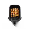 Chicken and vegetable skewers are arranged in an air fryer basket. Produktbild-Vorschau