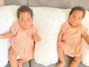 Two babies lying on a pillow on a couch. Voir les images du produit