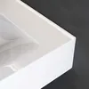 A close-up view of the edge and interior of a white ceramic sink with a dark gray background. Produktbild-Vorschau