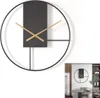 A minimalist wall clock with a black frame and a black rectangular face with wooden hands, shown against a white background. A smaller inset image shows the clock in a room setting. Produktbild-Vorschau