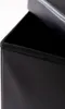 A close-up view of the top edge of a black storage ottoman. Náhled obrázku produktu