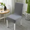 A grey chair cover on a chair, with a small table and a cactus in the background. Náhled obrázku produktu