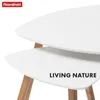 A close-up view of two white nesting tables with wooden legs, against a white background. Anteprima dell’immagine prodotto