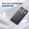 A black phone case with a carbon fiber look is shown on a flowing white and gray background, with feathers floating around it. Produktbild-Vorschau