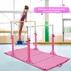 A young girl is practicing on a pink gymnastics bar set in a gym. Anteprima dell’immagine prodotto