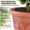 A close-up of a terracotta-colored plant pot with text overlays highlighting its features and origin. Produktbild-Vorschau
