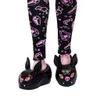 Close-up of a doll's feet wearing bat-themed slippers. Anteprima dell’immagine prodotto