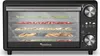 A black TurboTronic food dehydrator filled with various dried fruits on its shelves. Produktbild-Vorschau