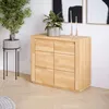 A wooden dresser with plants and decorative items in a room. Produktbild-Vorschau