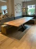 A dining room with a long wooden table and a built-in bench. Produktbild-Vorschau