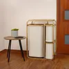 A laundry basket with three bags and a small side table with a plant and a phone. Podgląd zdjęcia produktu