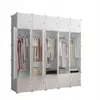 A modular white wardrobe with several compartments filled with clothes. Anteprima dell’immagine prodotto