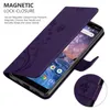 A purple flip case for a Nokia phone, shown open with the phone screen visible. The case has a floral pattern. Text describes the magnetic closure feature. Náhled obrázku produktu