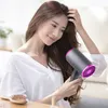 A woman is drying her hair with a hairdryer. Produktbild-Vorschau