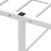 Close-up view of a white metal bed frame corner with a black plastic cap. Produktbild-Vorschau